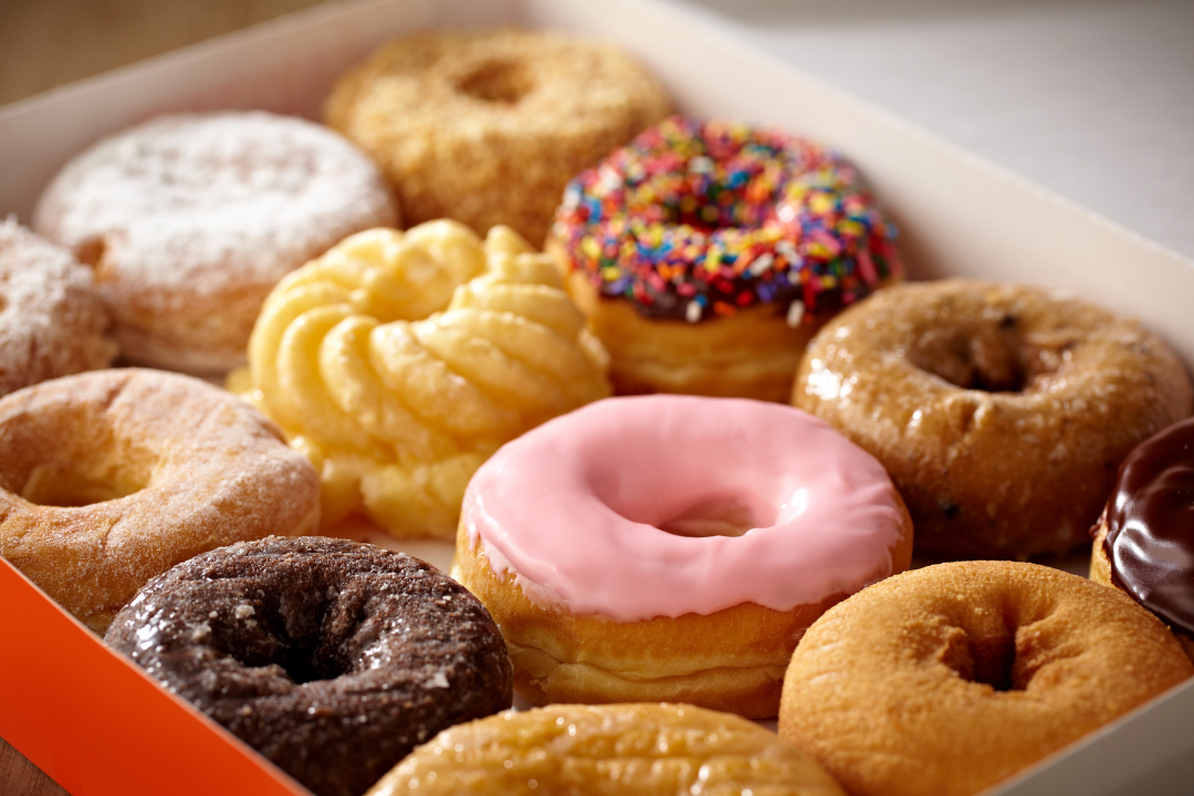 An open variety open box of doughnuts.