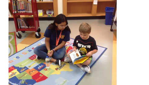 boy reading to teen buddy