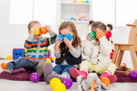 Children playing with colorful toy balls.