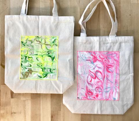 Two tote bags decorated with marbled art