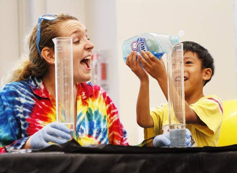 An adult and child excited over a science experiment.