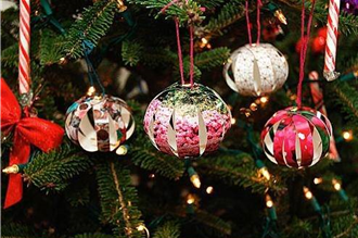 round ornaments made out of photos cut into strips and hanging on a Christmas tee