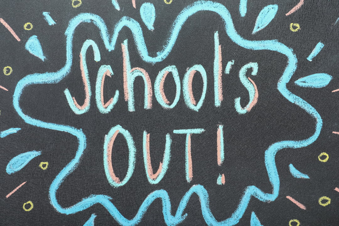 The words SCHOOL'S OUT! on a blackboard