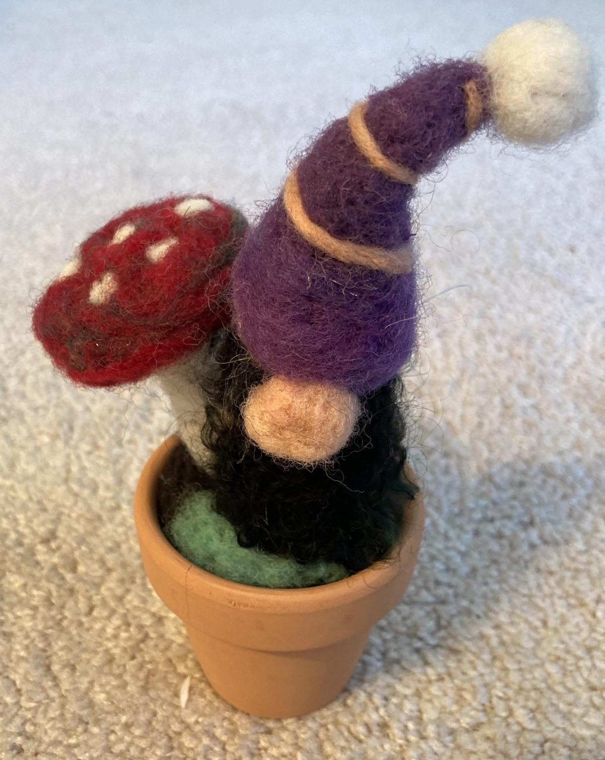 Felted gnome in flower pot with mushroom
