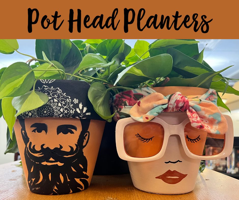 Planters painted with faces, one man, one woman