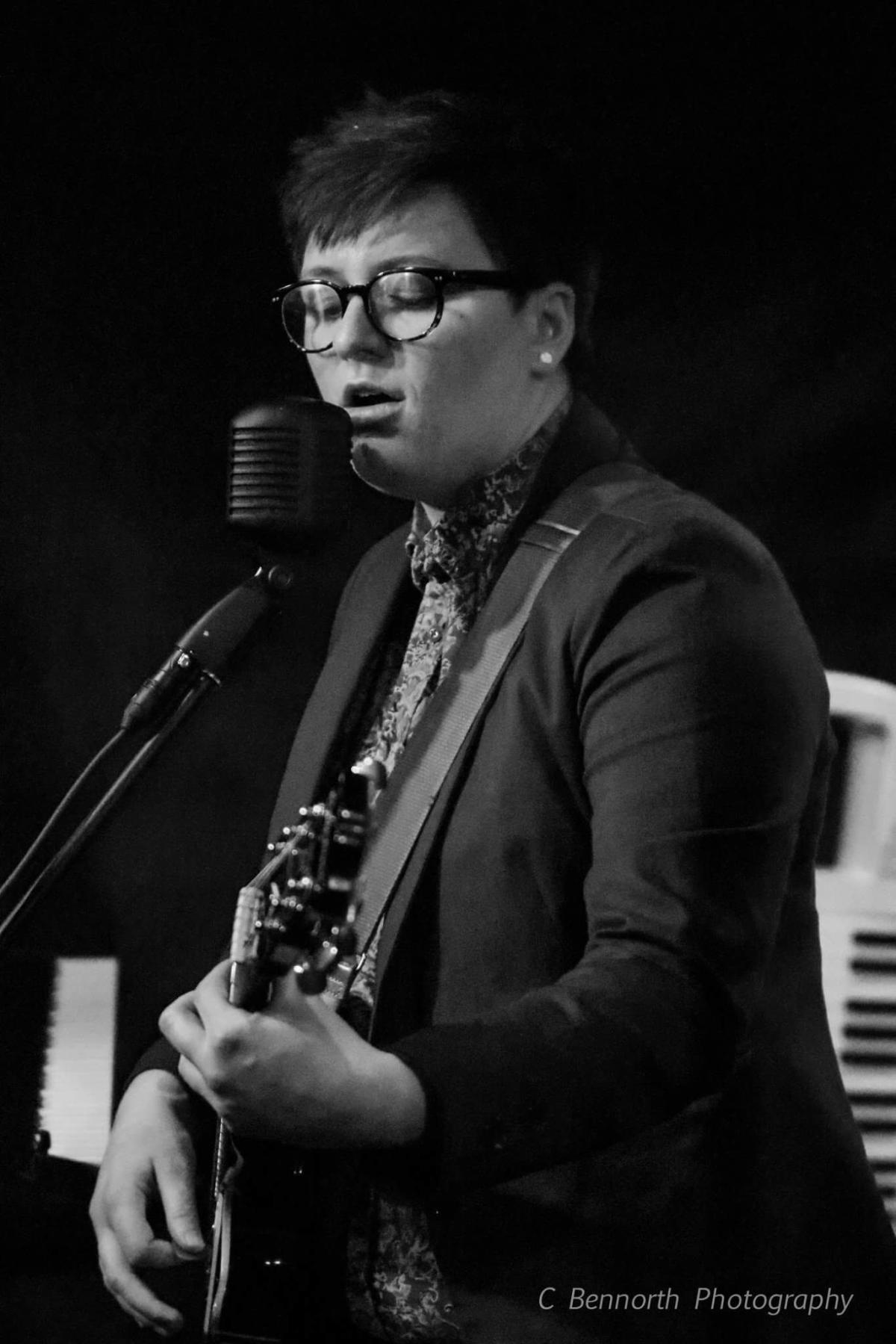 Katie Bogle performing on stage.