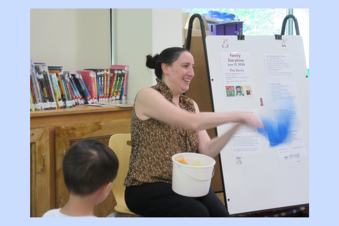 A teacher singing a song with scarves.