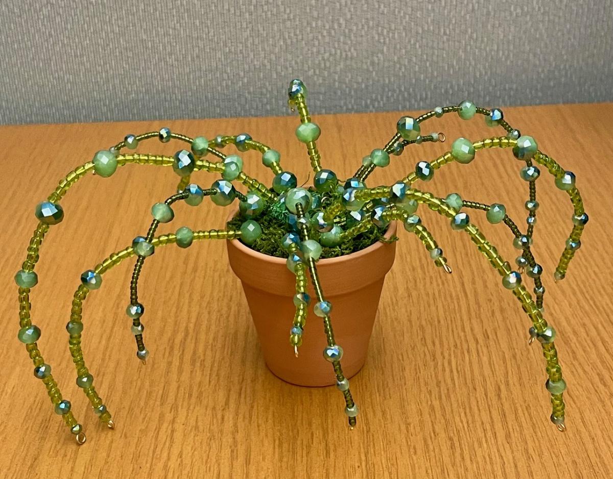 small pot with plant made of various sized beads